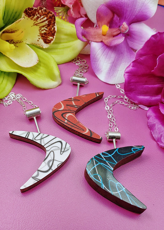Boomerang laminate necklaces with colorful flowers