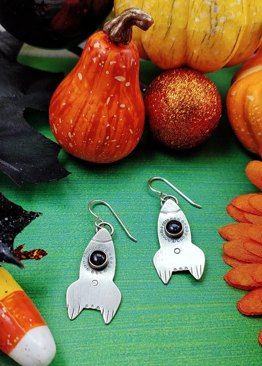 Rocket ship earrings in a fall setting
