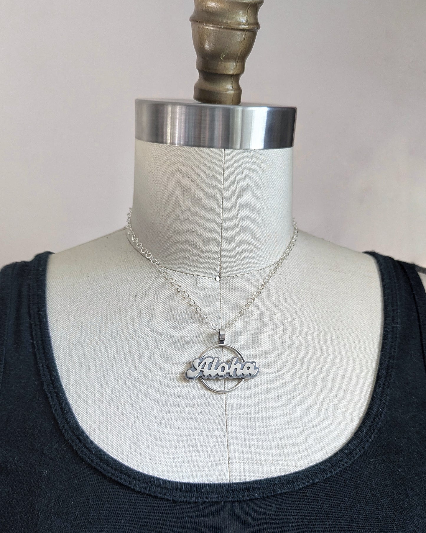 Silver Aloha necklace on a dress form