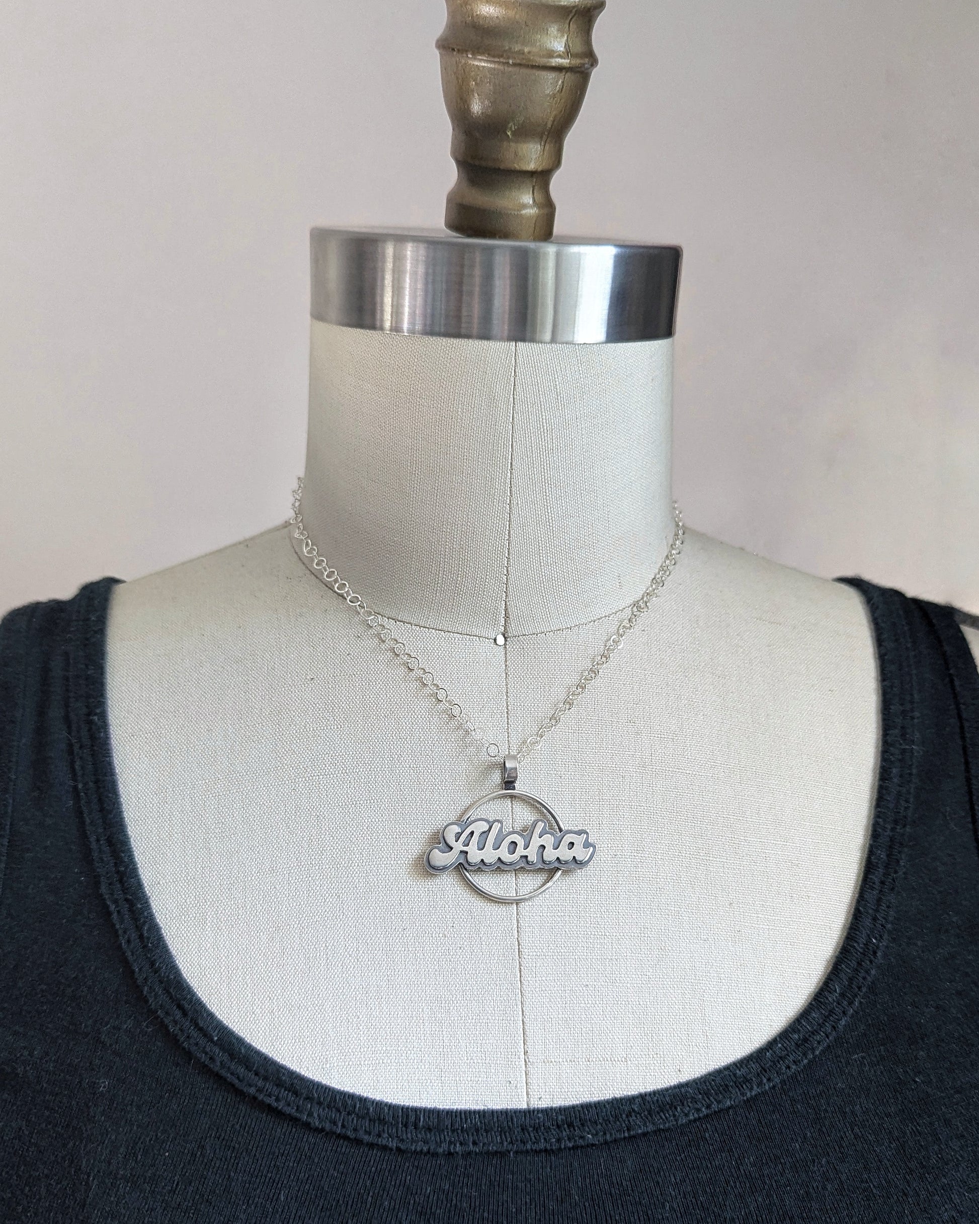 Silver Aloha necklace on a dress form