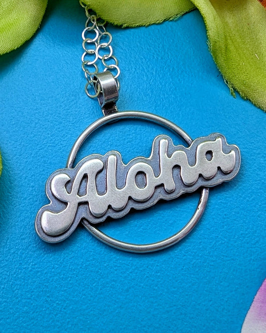 Sterling silver Aloha necklace on turquoise background