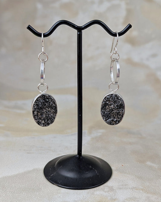Sterling silver dangled earrings featuring sparkly black druzy
