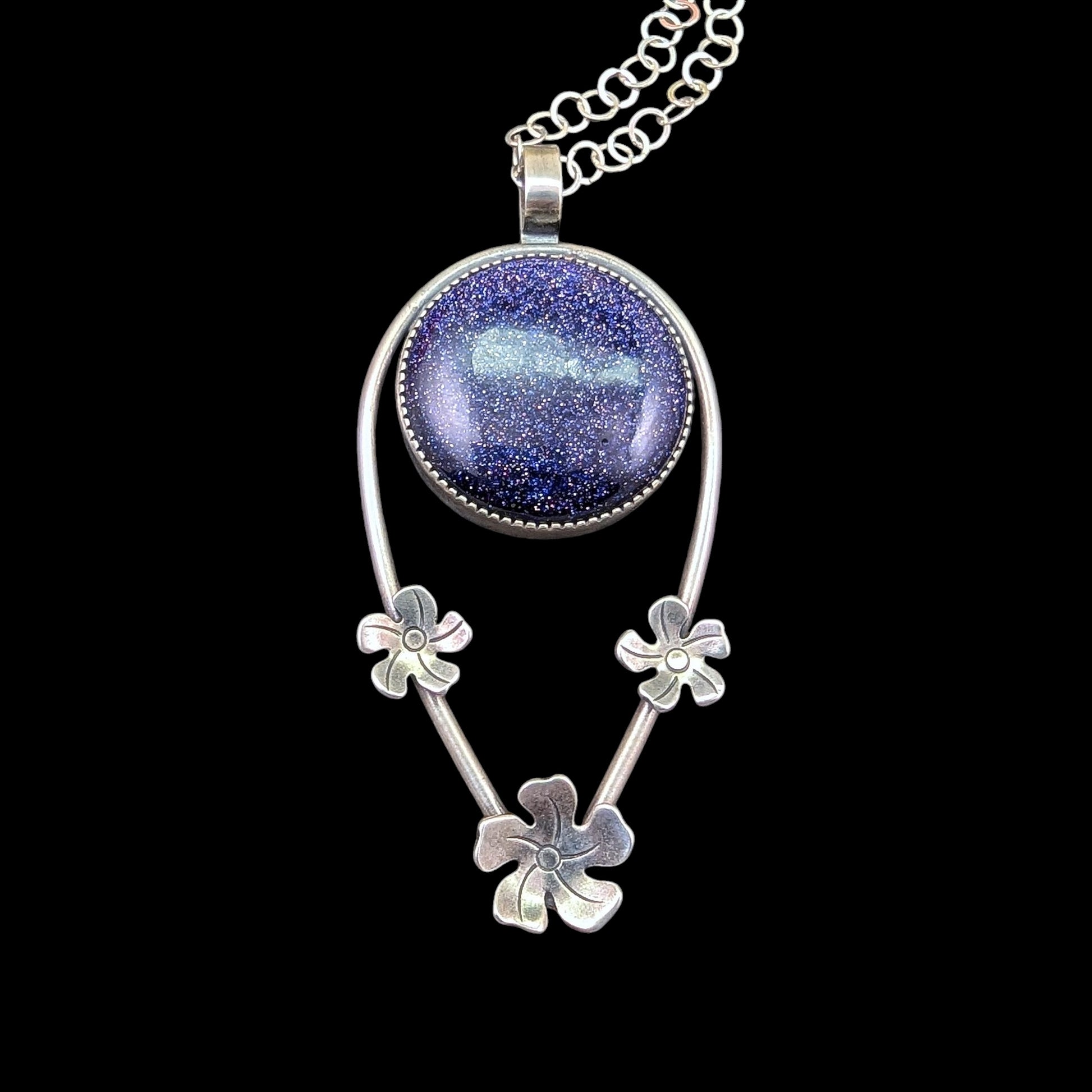 Blue goldstone sterling silver necklace with flowers on black background that will make a perfect accessory for any tiki outfit or every day