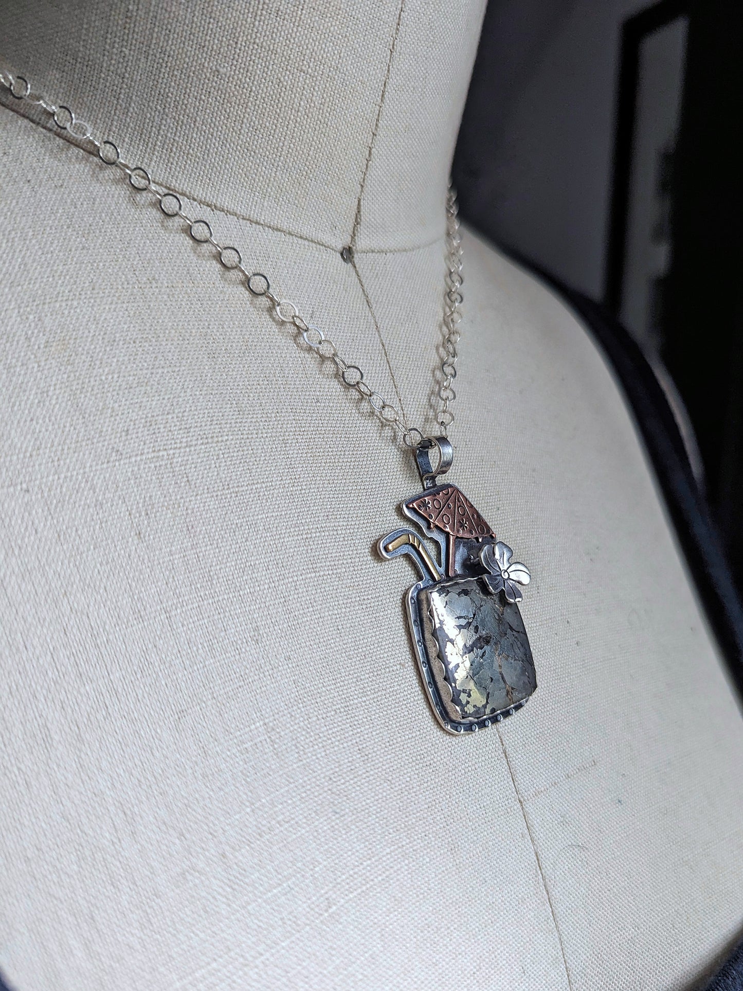 Tiki drink necklace shown from the side