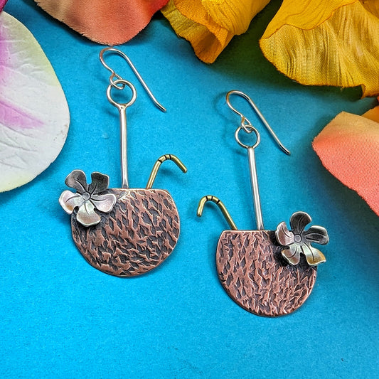 Hammered copper coconut drop Tiki earrings with patina and sterling silver flower and brass straw.