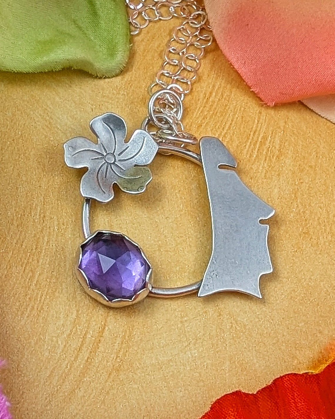 Sterling silver moai head necklace with flower and rosecut amethyst