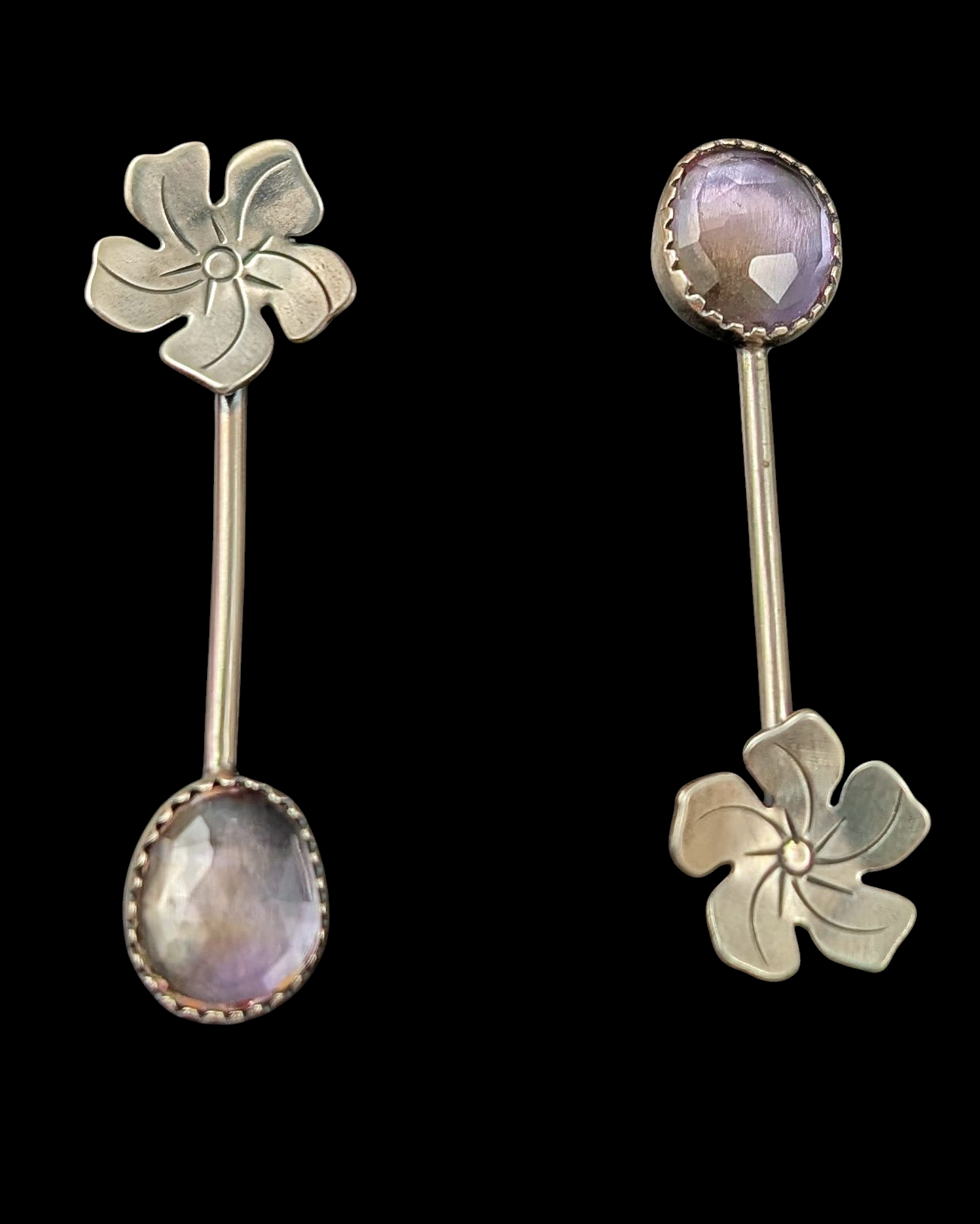 Sterling silver flower and purple yellow ametrine drop earrings with posts on a black background