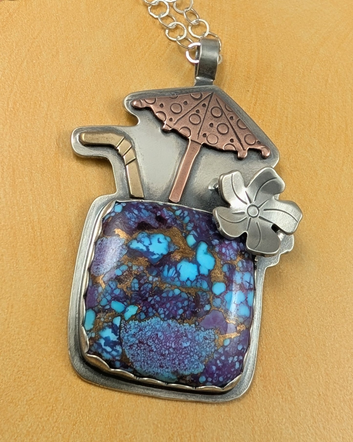 Purple copper turquoise tiki drink necklace on yellow background