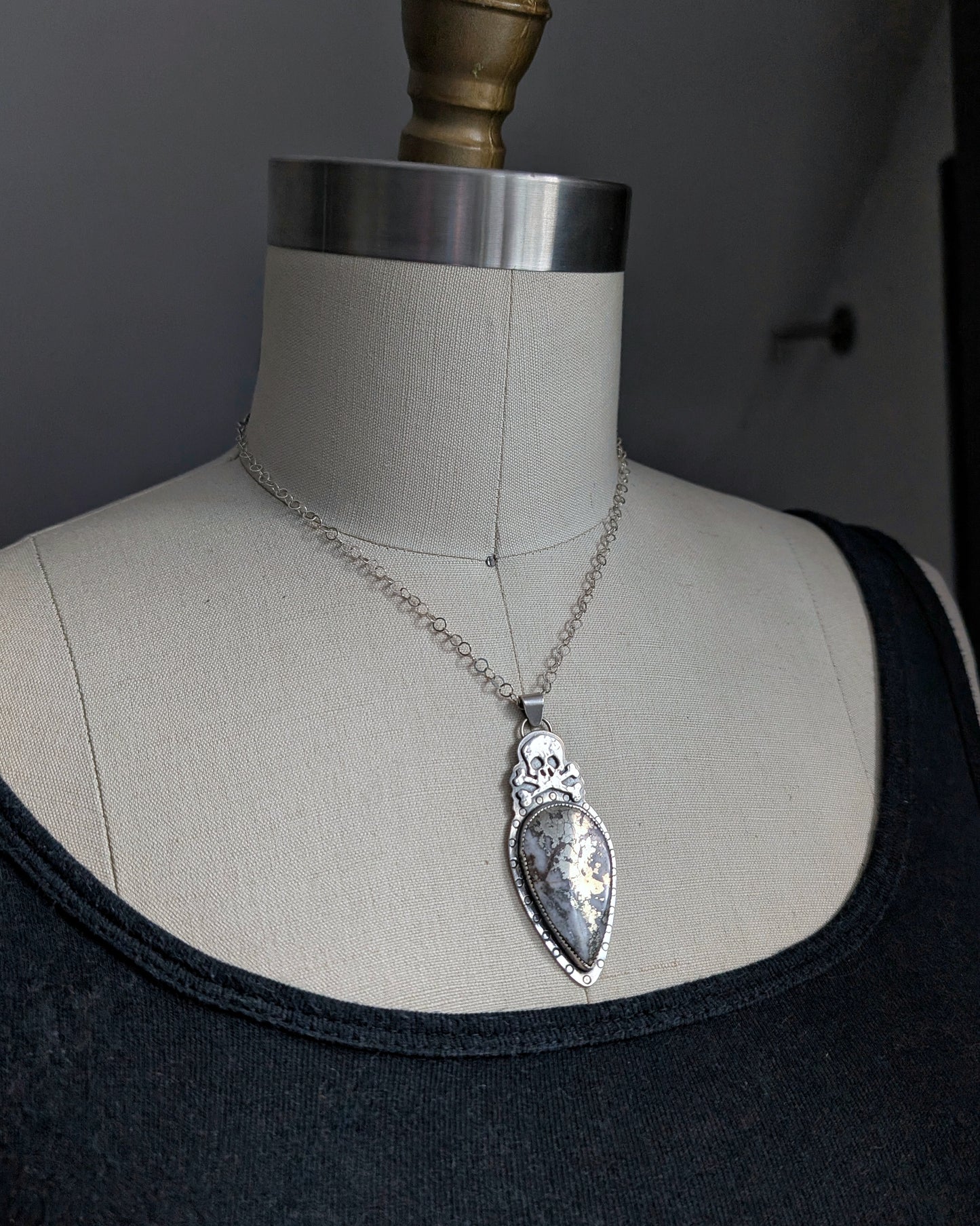 Sterling silver skull necklace with marcasite on a mannequin