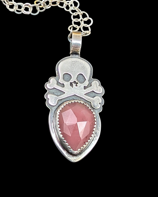 Sterling silver skull with rosecut guava quartz necklace on black background