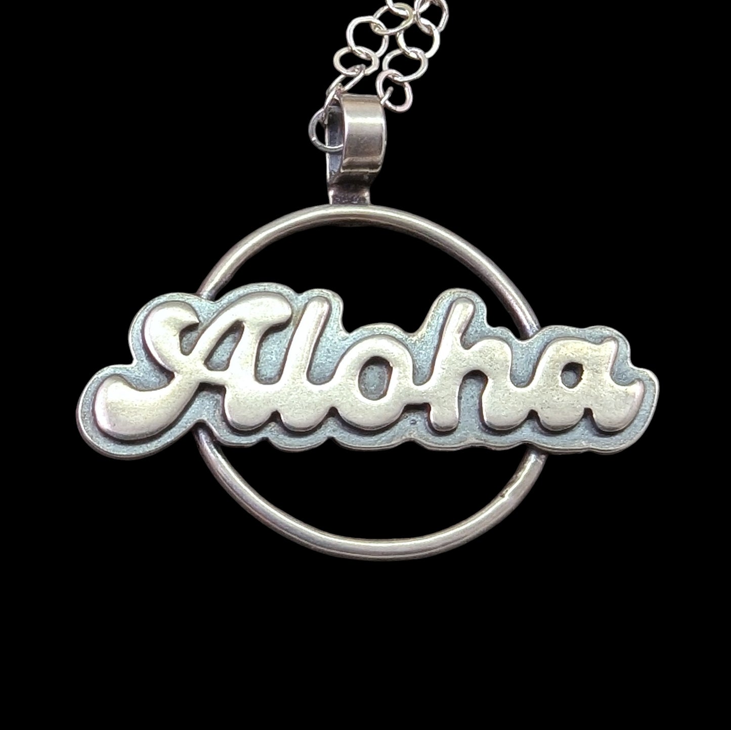 Sterling silver aloha greeting necklace on black background