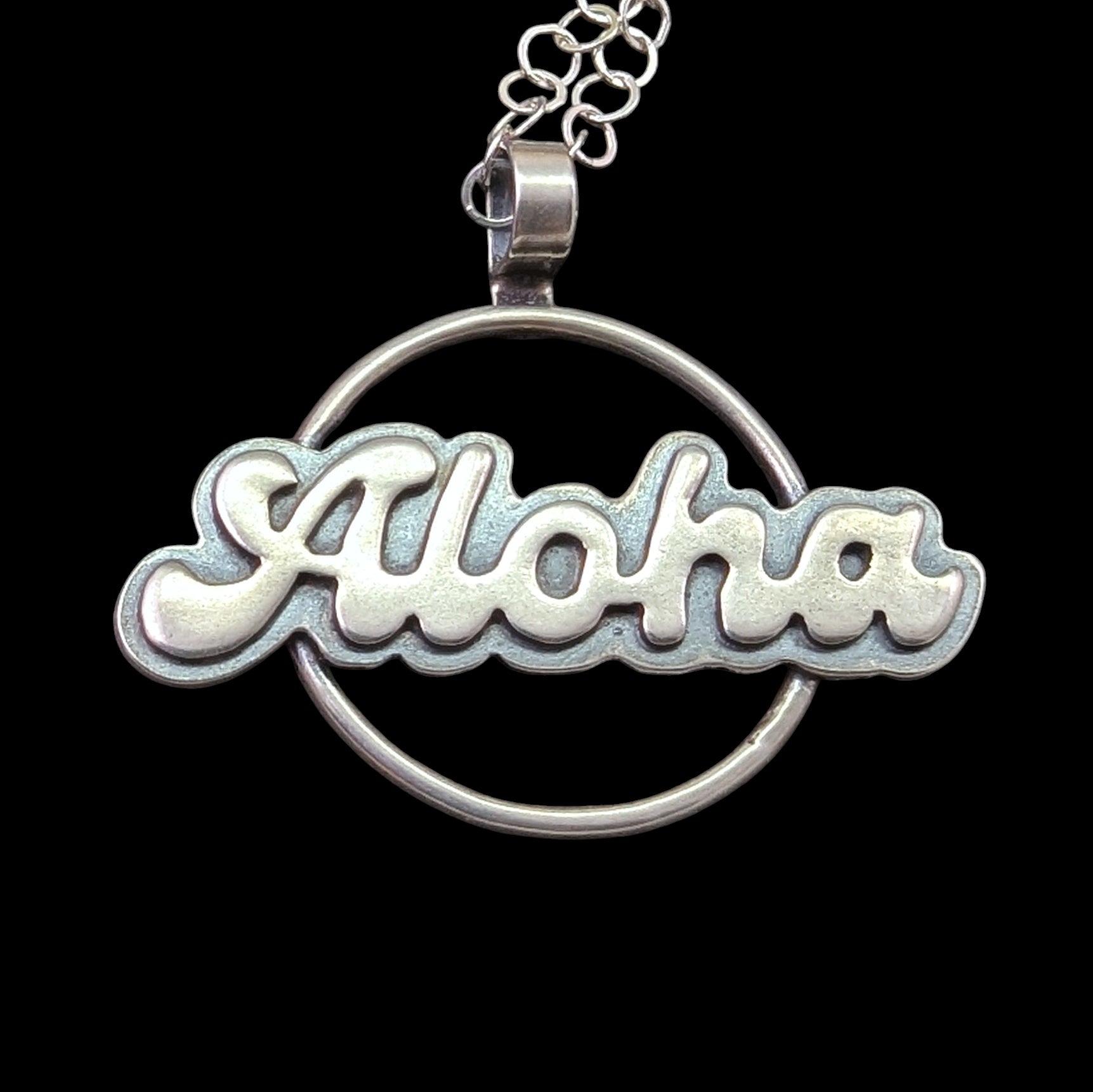Sterling silver aloha greeting necklace on black background