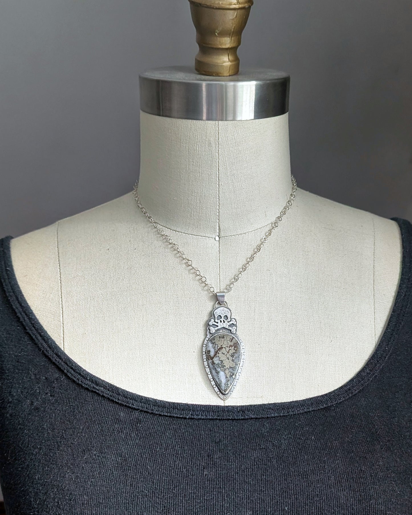 Sterling silver skull necklace with marcasite on a mannequin