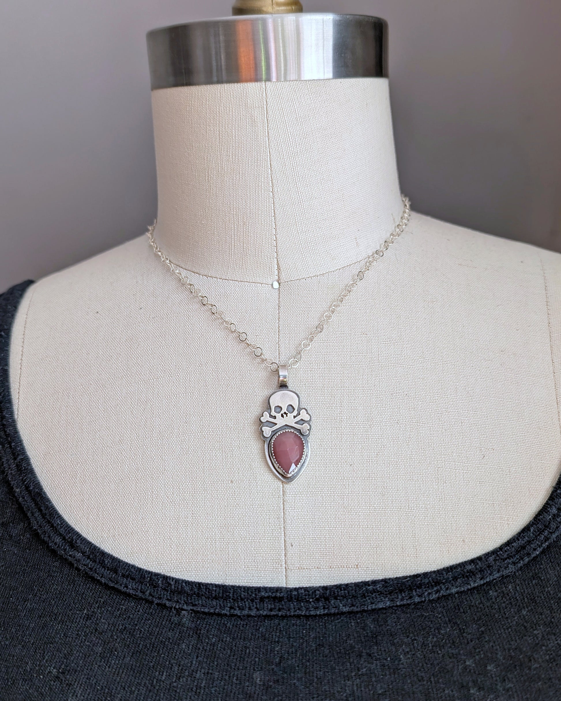 Sterling silver skull with rosecut guava quartz necklace on mannequin