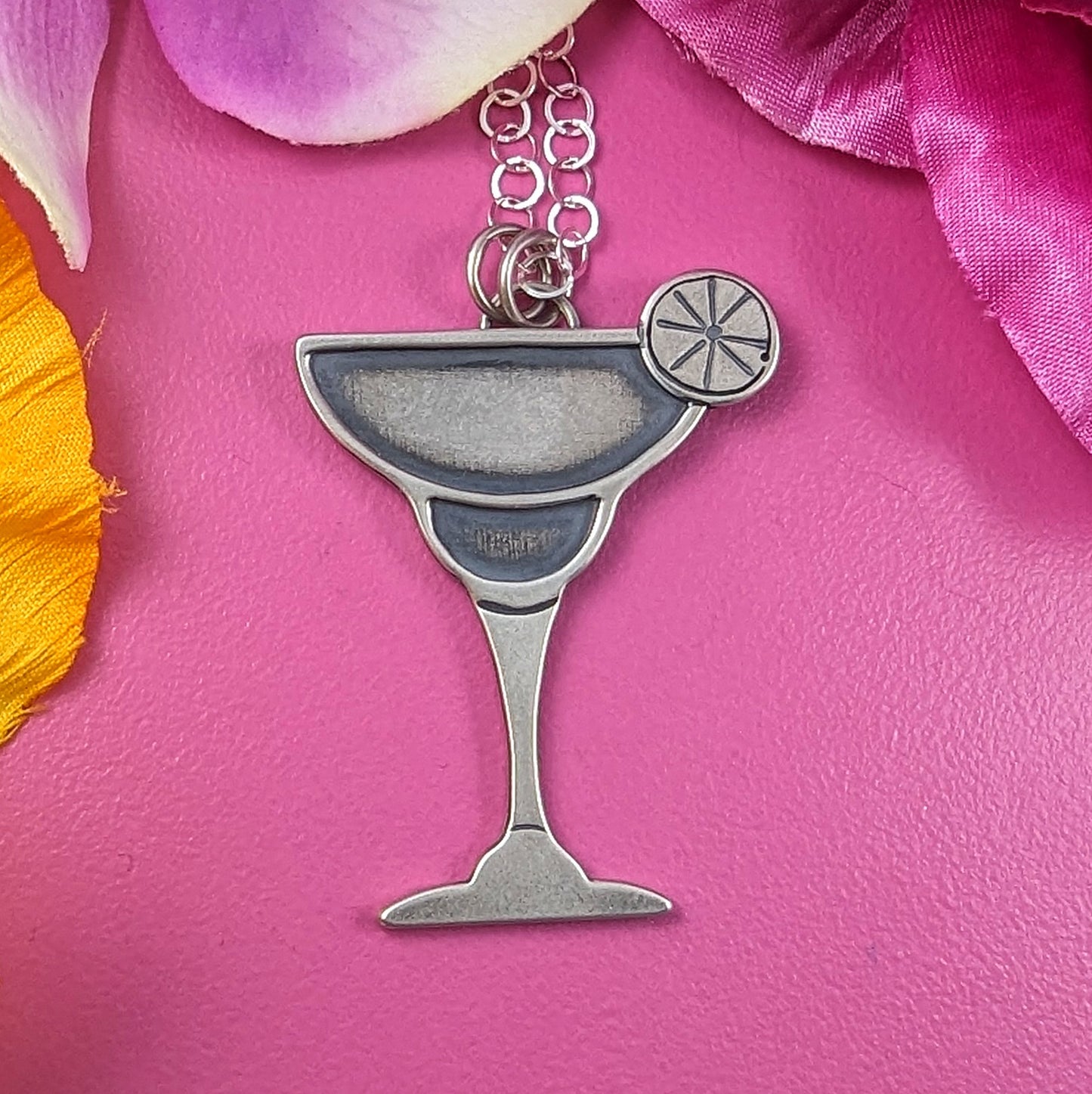Margarita drink cocktail necklace handmade in sterling silver on a pink background