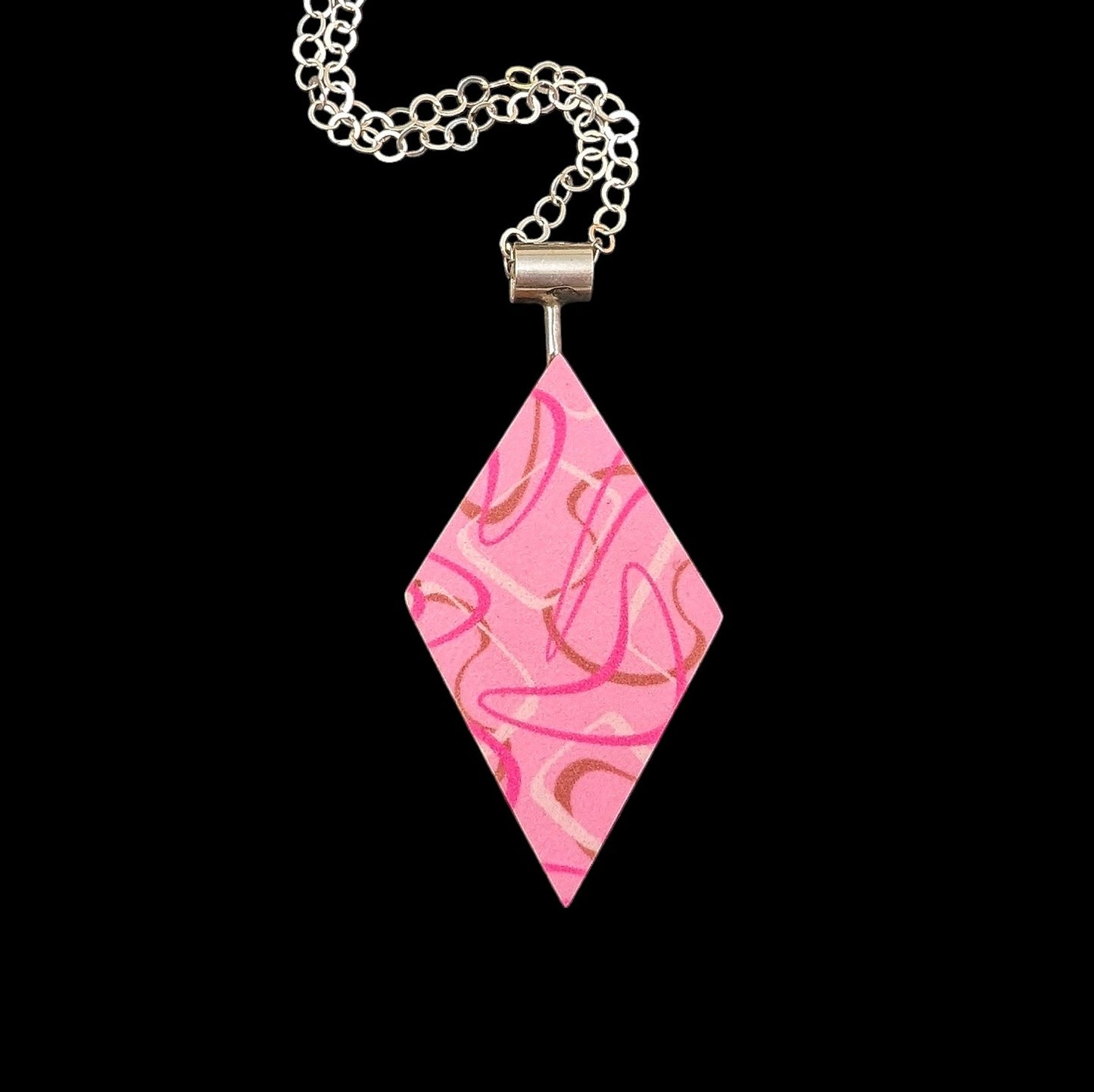 Pink boomerang laminate diamond shaped necklace with a retro aesthetic