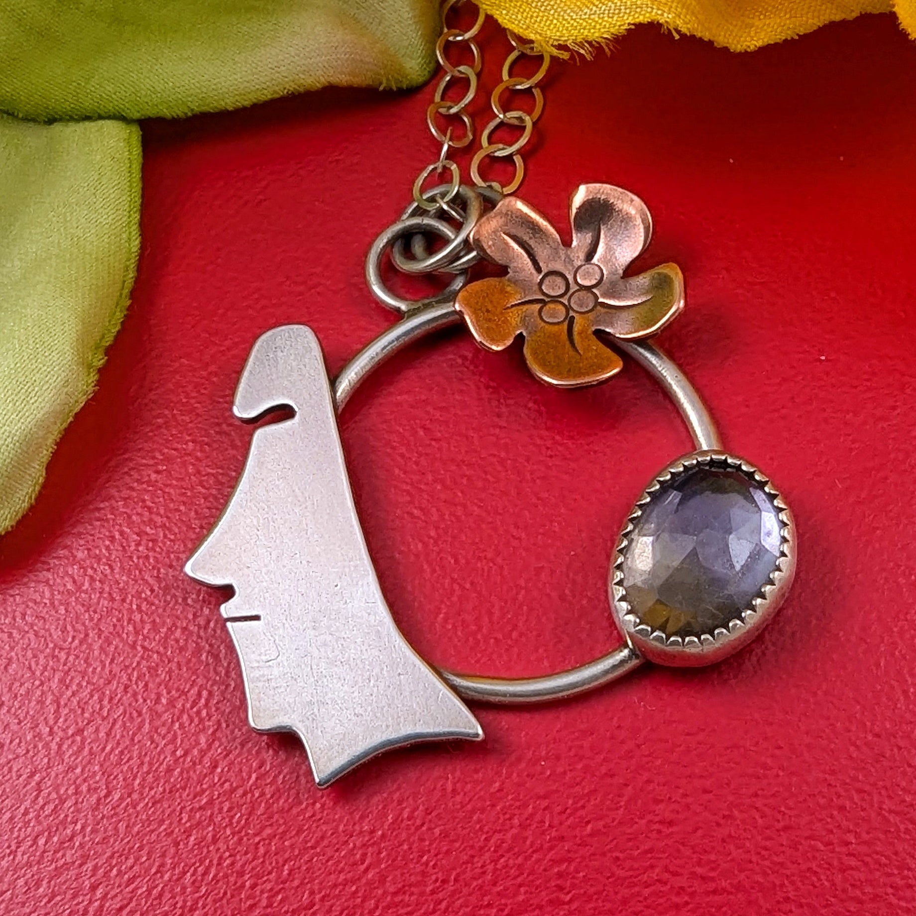 Easter Island Moai statue sterling silver and copper necklace with purple and yellow stone on red background