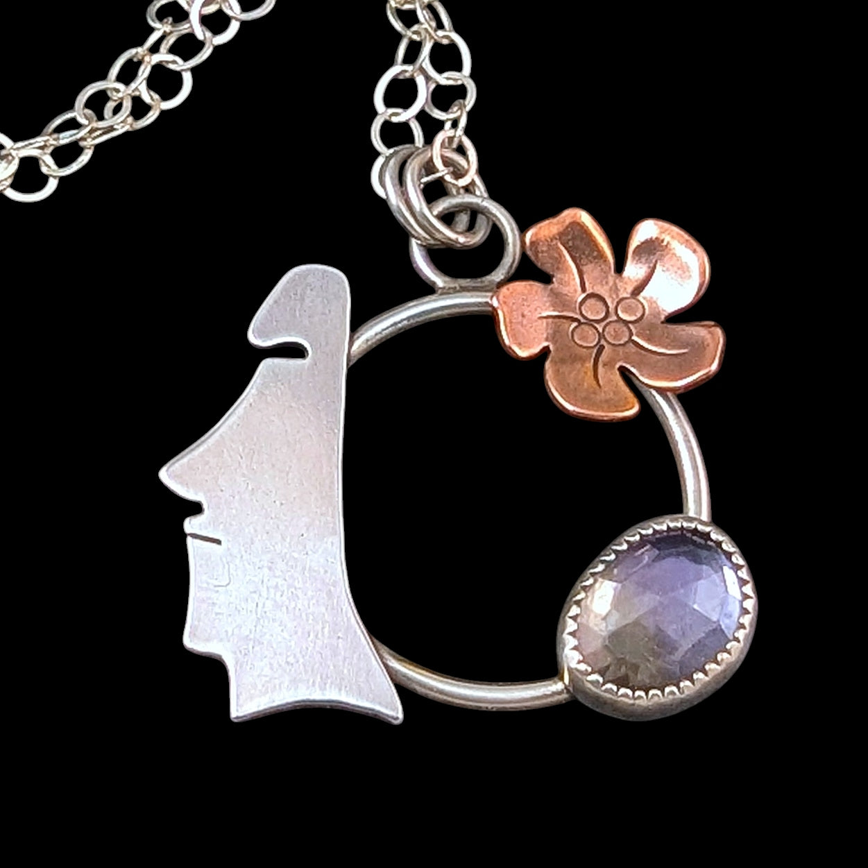 Easter Island Moai statue sterling silver and copper necklace with purple and yellow stone on black background