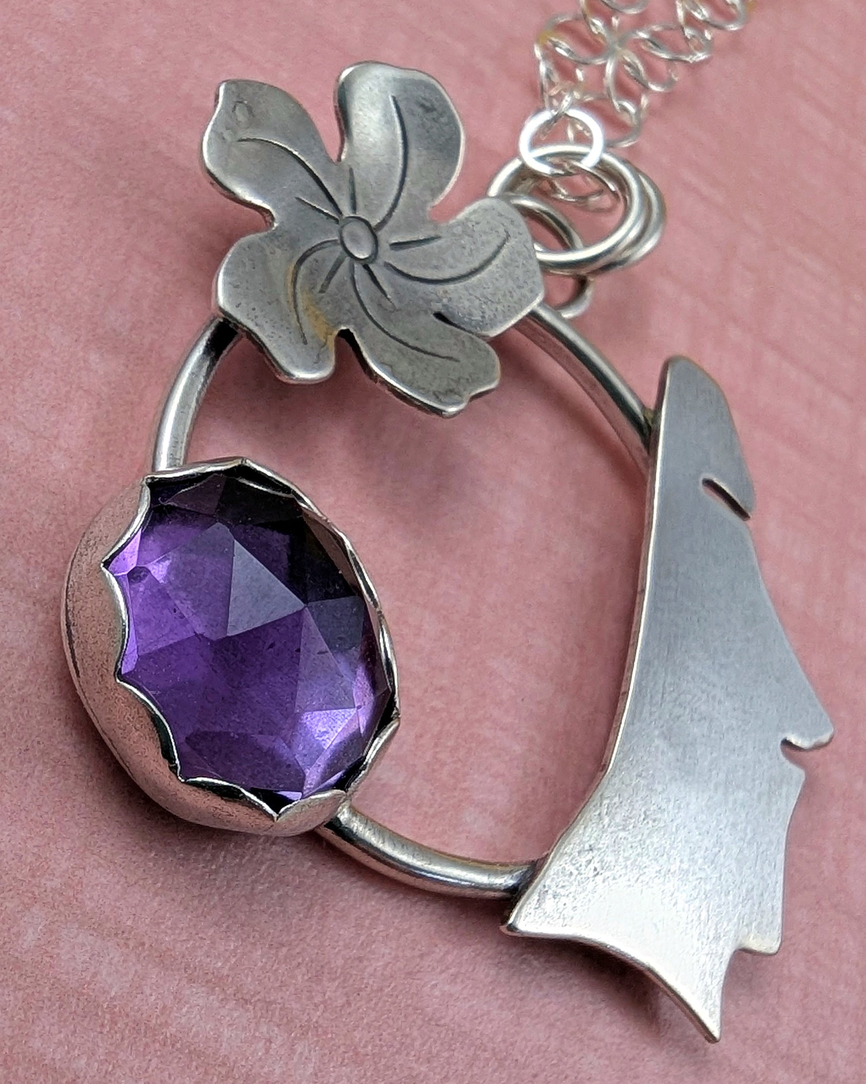 Up close view of moai necklace with amethyst