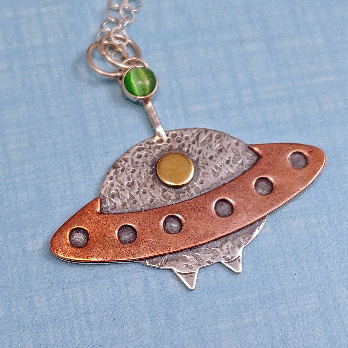 Handmade sterling silver, copper, brass and gemstone spaceship necklace.