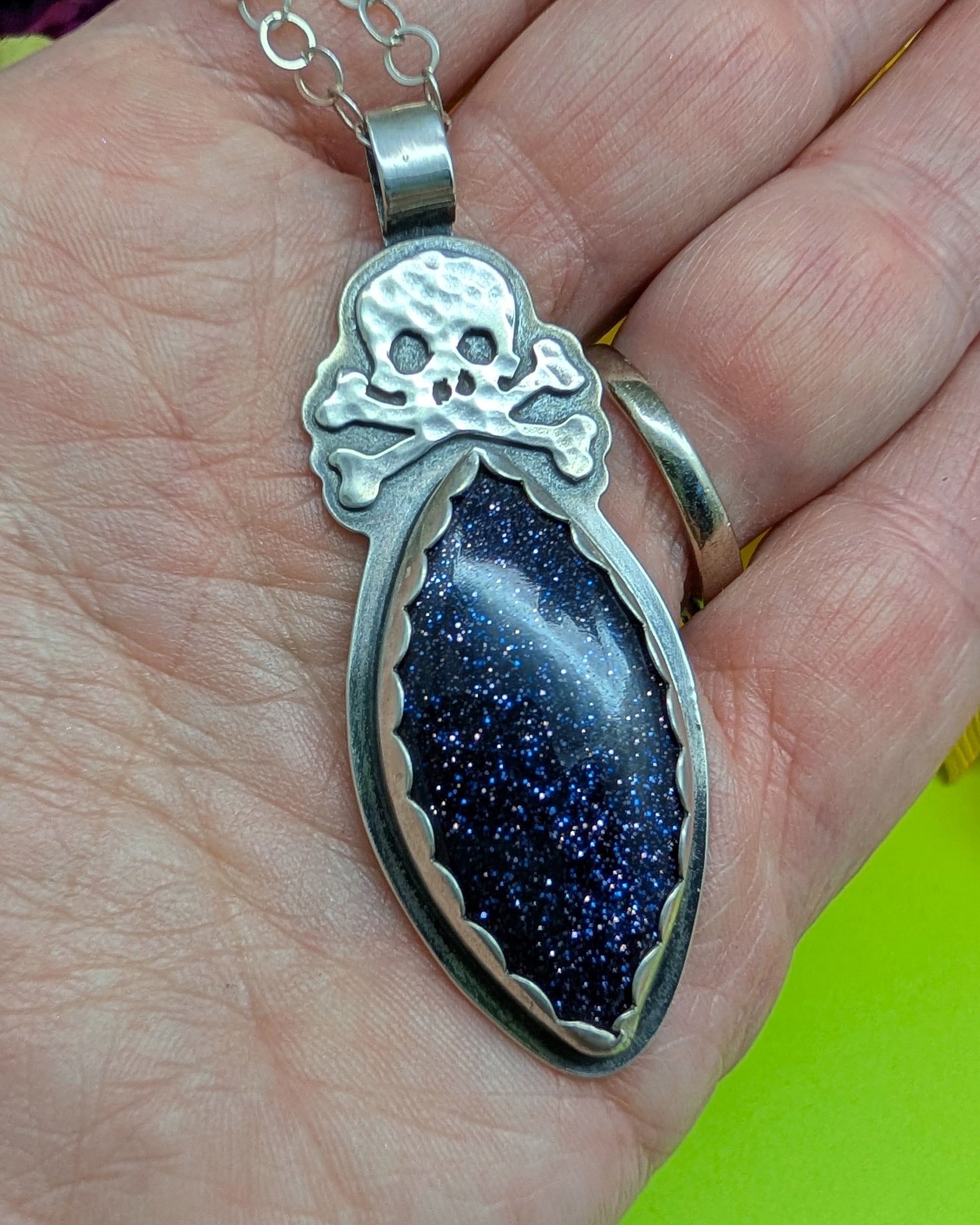 Sterling silver skull necklace with blue goldstone