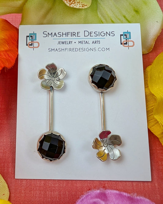 Pair of floral earrings on a Smashfire Designs card with colorful flowers in the background.