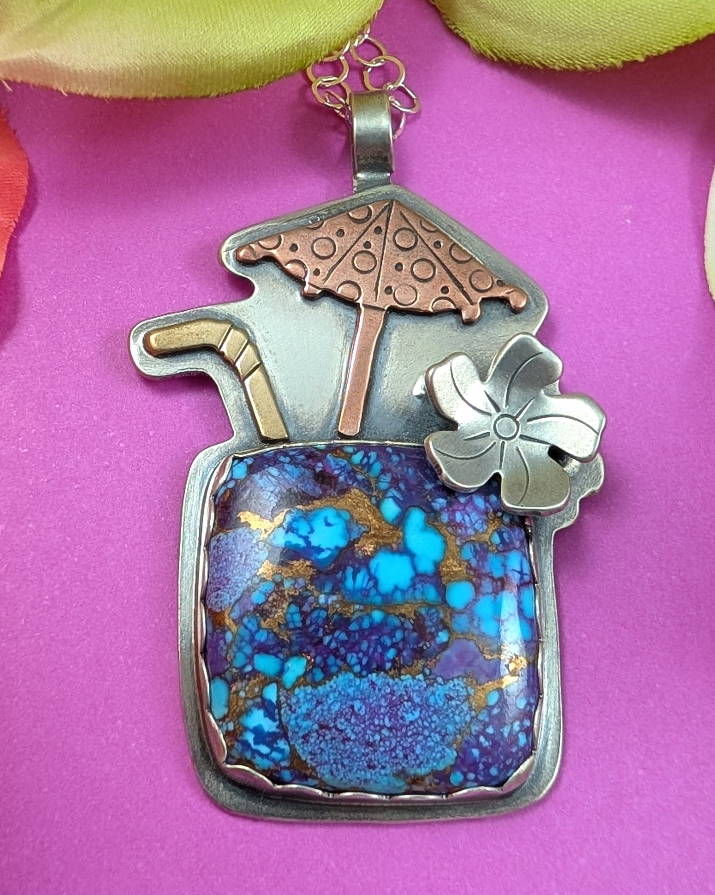 Purple copper turquoise tiki drink necklace on magenta background