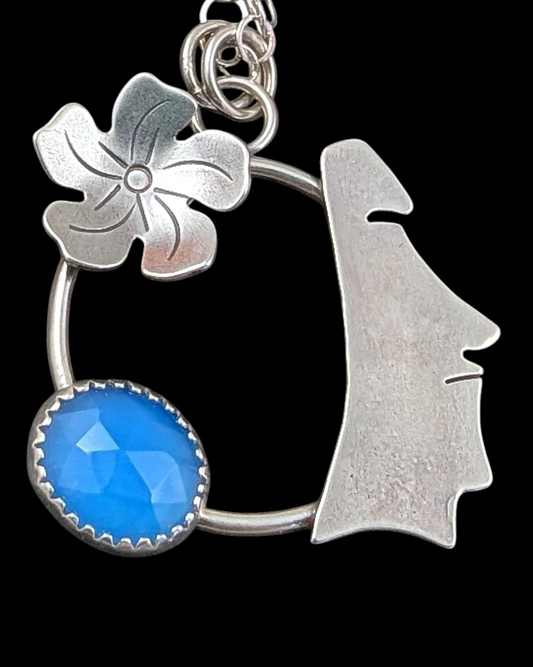 Close up sterling silver moai head with blue chalcedony necklace