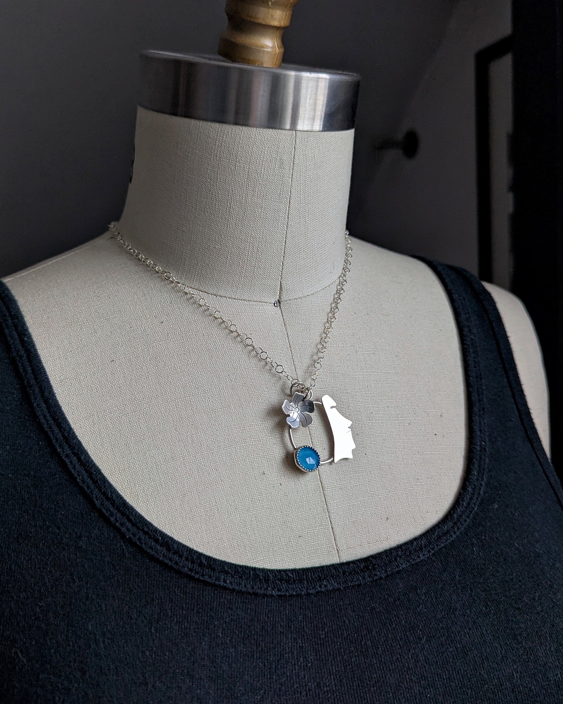View of moai necklace on dress form