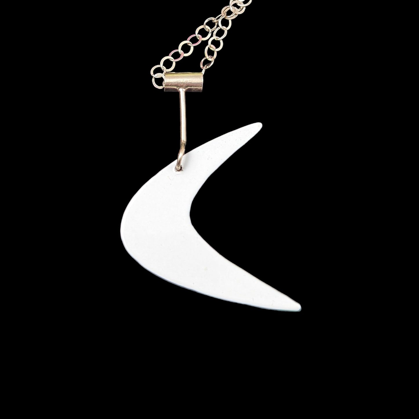 Mid mod inspired boomerang necklace in powdercoated brass and sterling silver in the color white