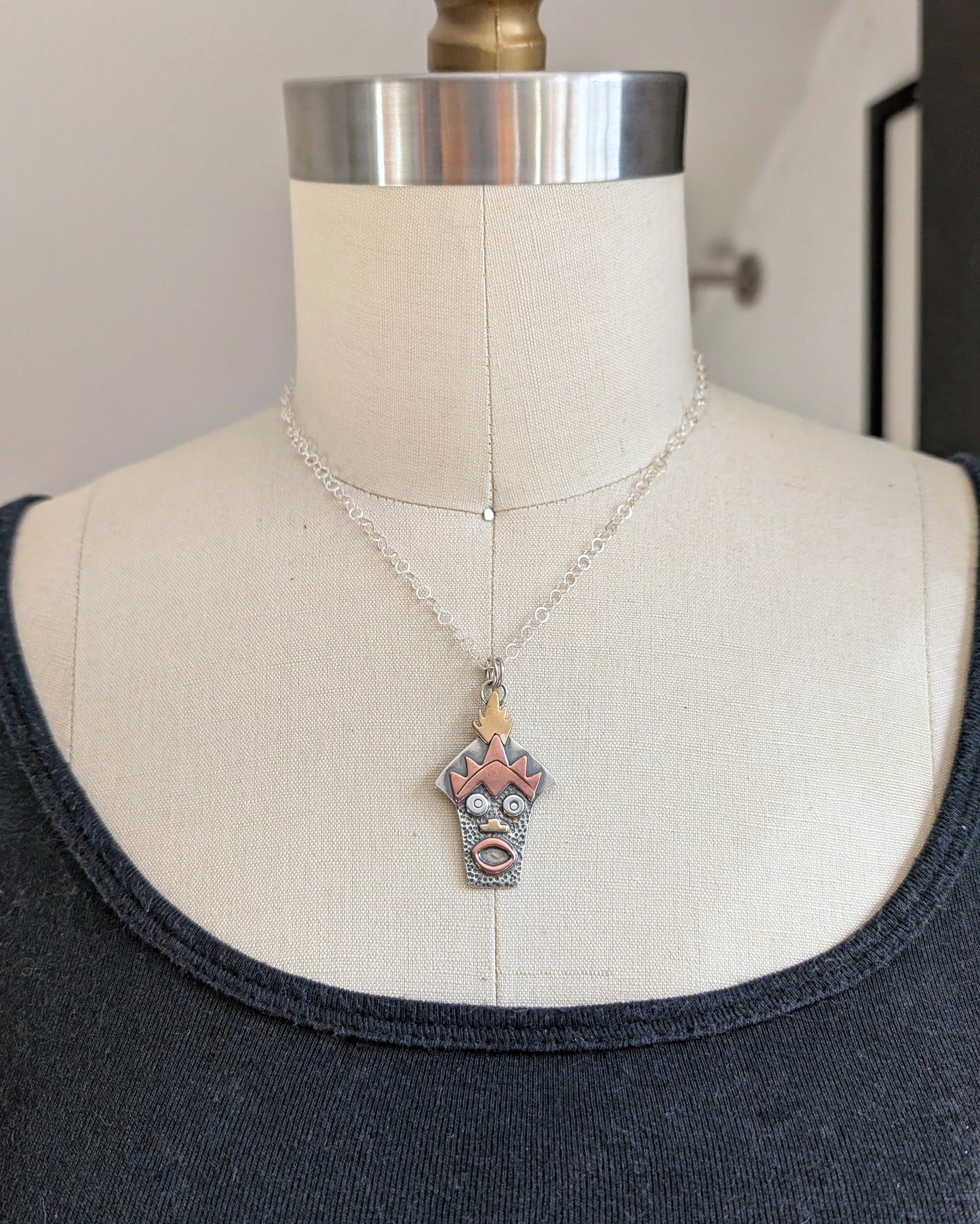 Sterling silver Witch Doctor with Hawaiian mask necklace on a mannequin