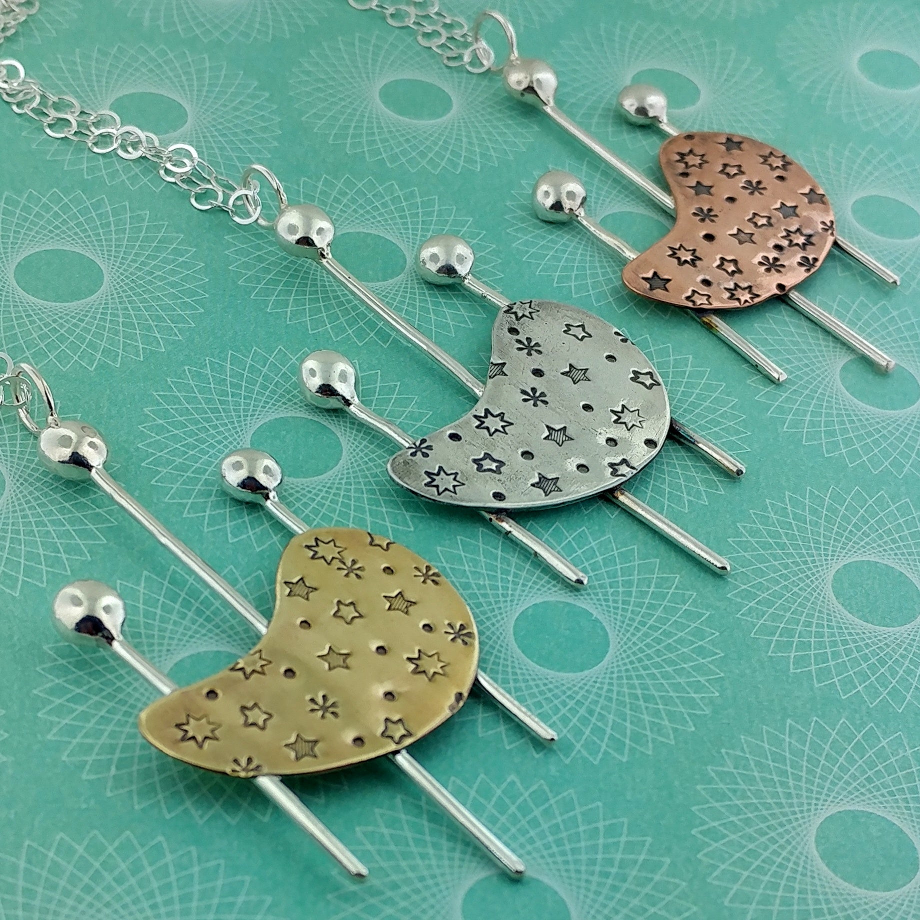 Googie inspired handmade necklaces with a kidney shape using sterling silver, copper, and brass