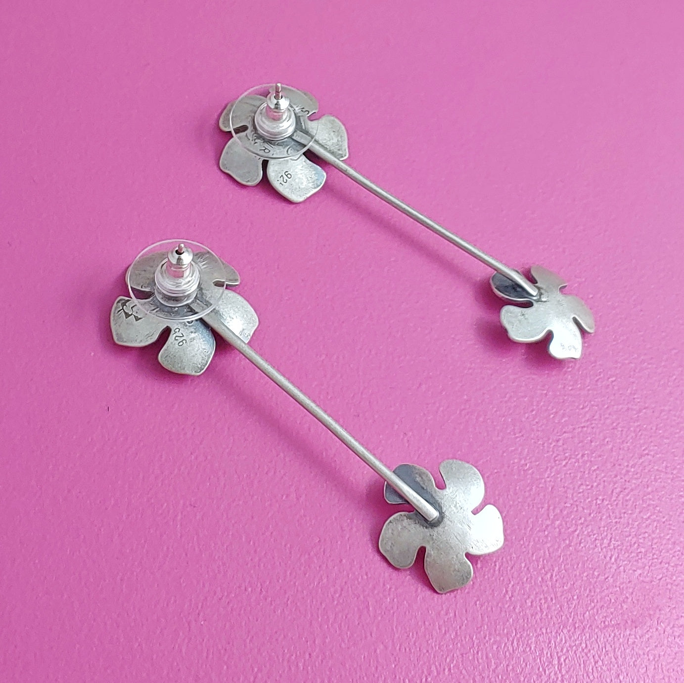 Backside of sterling silver plumeria stud earrings with flower dangles