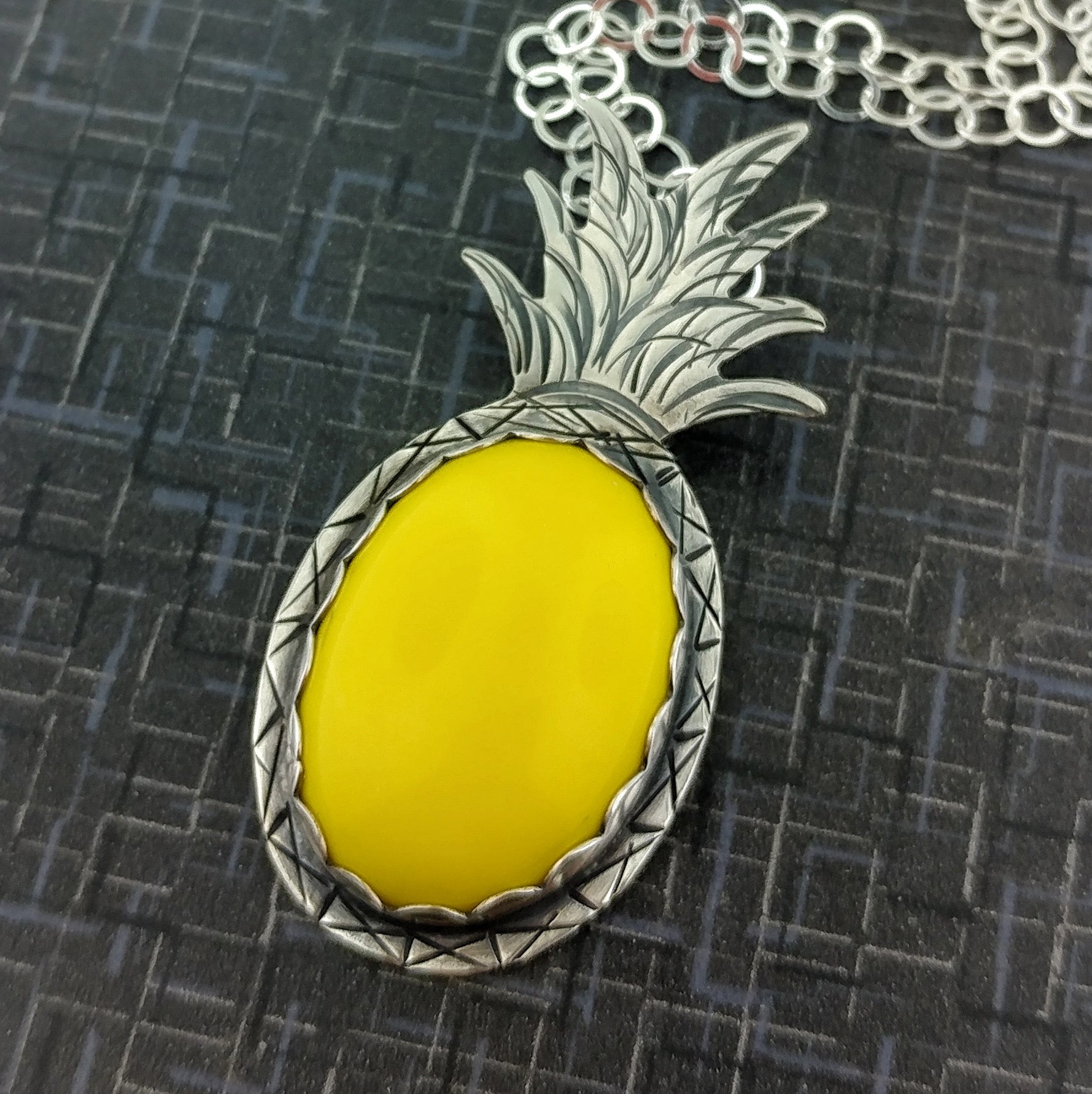 Yellow lucite stone in a Tiki inspired pineapple necklace in sterling silver