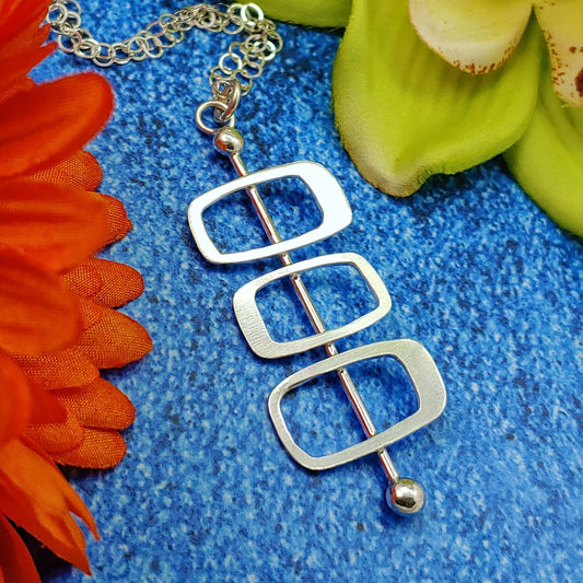 Handmade sterling silver modernist necklace featuring Googie inspired architectural soft rectangles