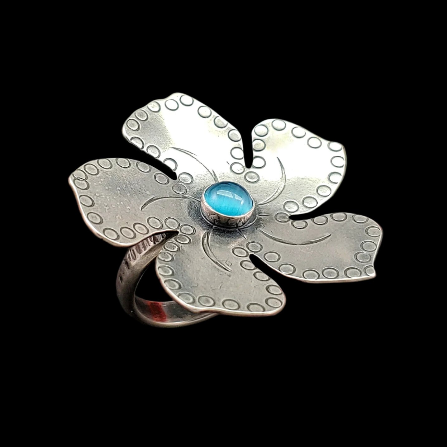 Handmade Sterling silver plumeria Tiki ring with light blue stone with fine detailing showing a different angle