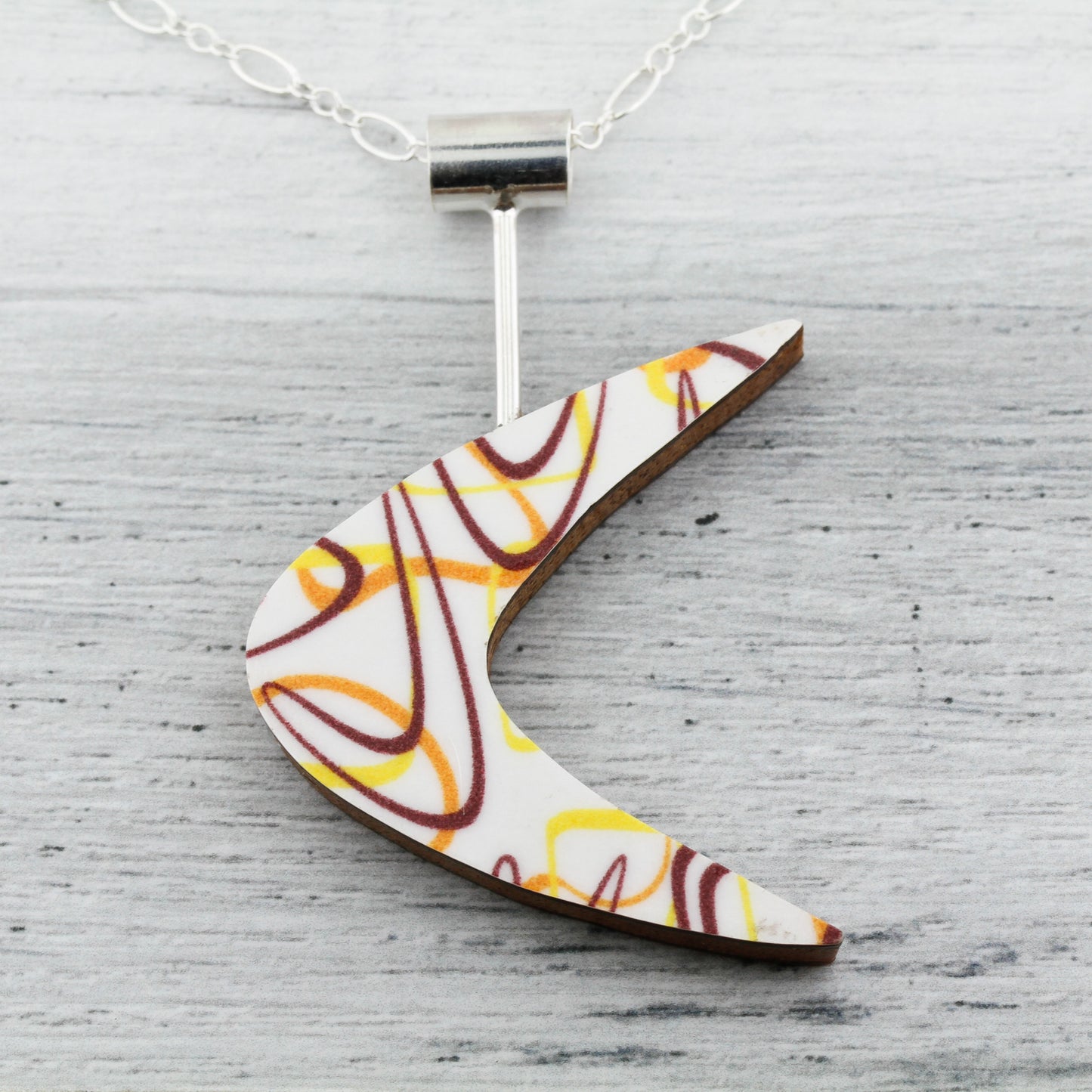 Boomerang Shaped Reversible Laminate Necklace - Orange/Yellow/Brown