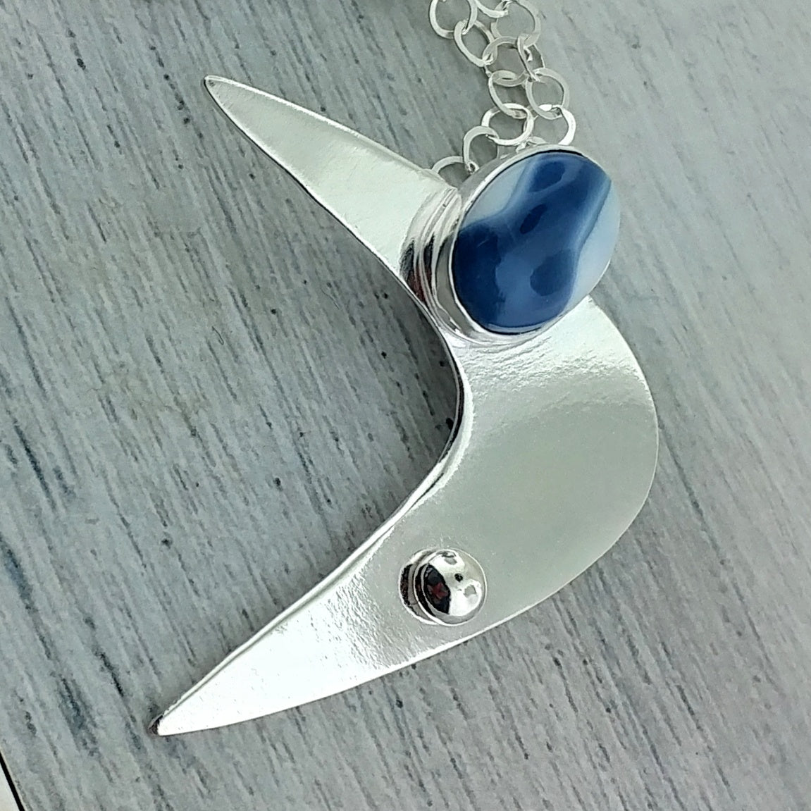 Blue opal and sterling silver modernist necklace featuring a googie inspired boomerang