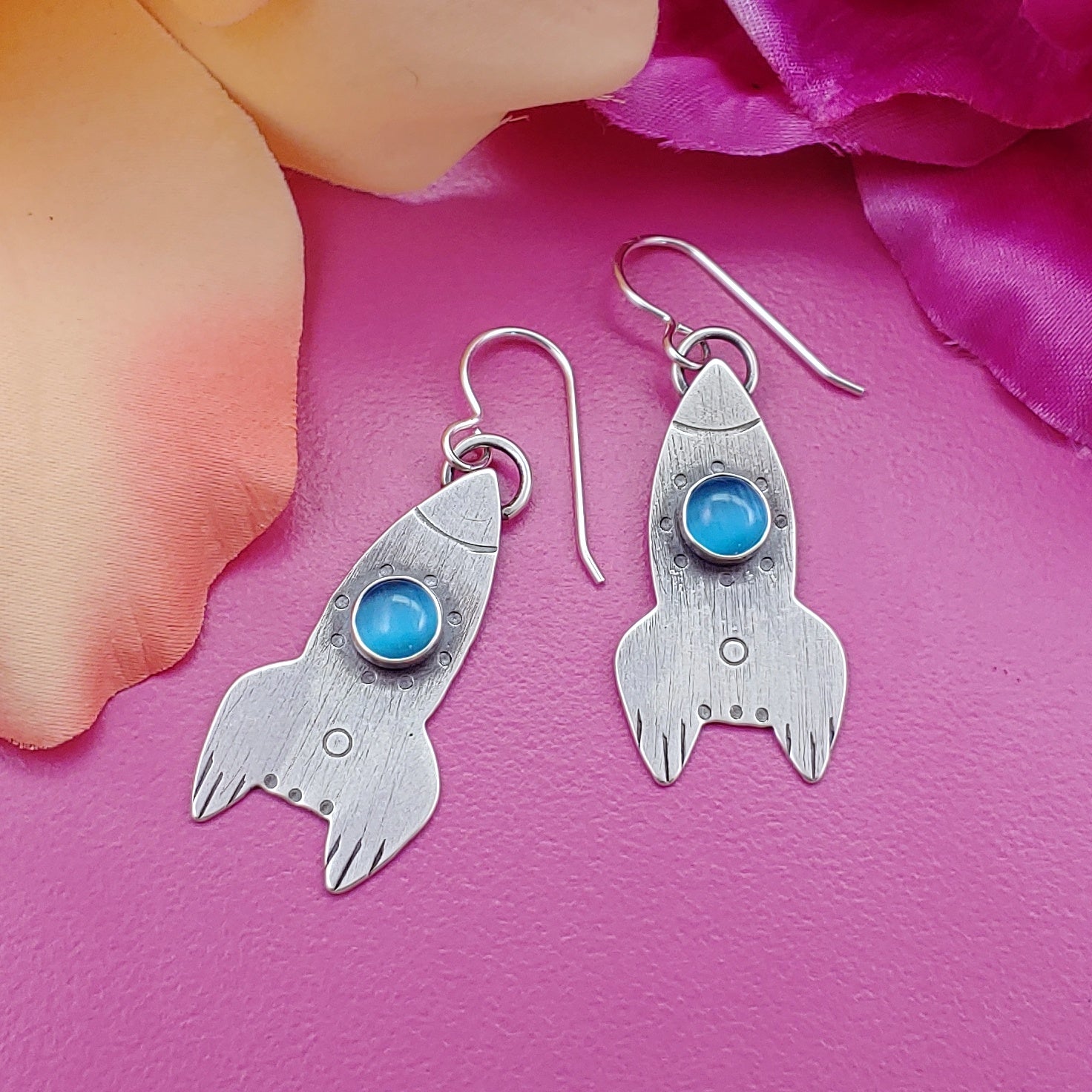 Handmade sterling silver rocket ship earrings with blue cats eye stone