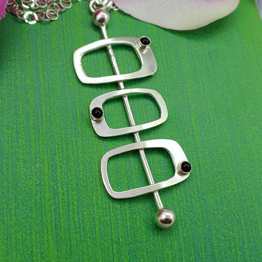 Sterling silver soft rectangles necklace in mid century modern aesthetic and Googie inspired architecture