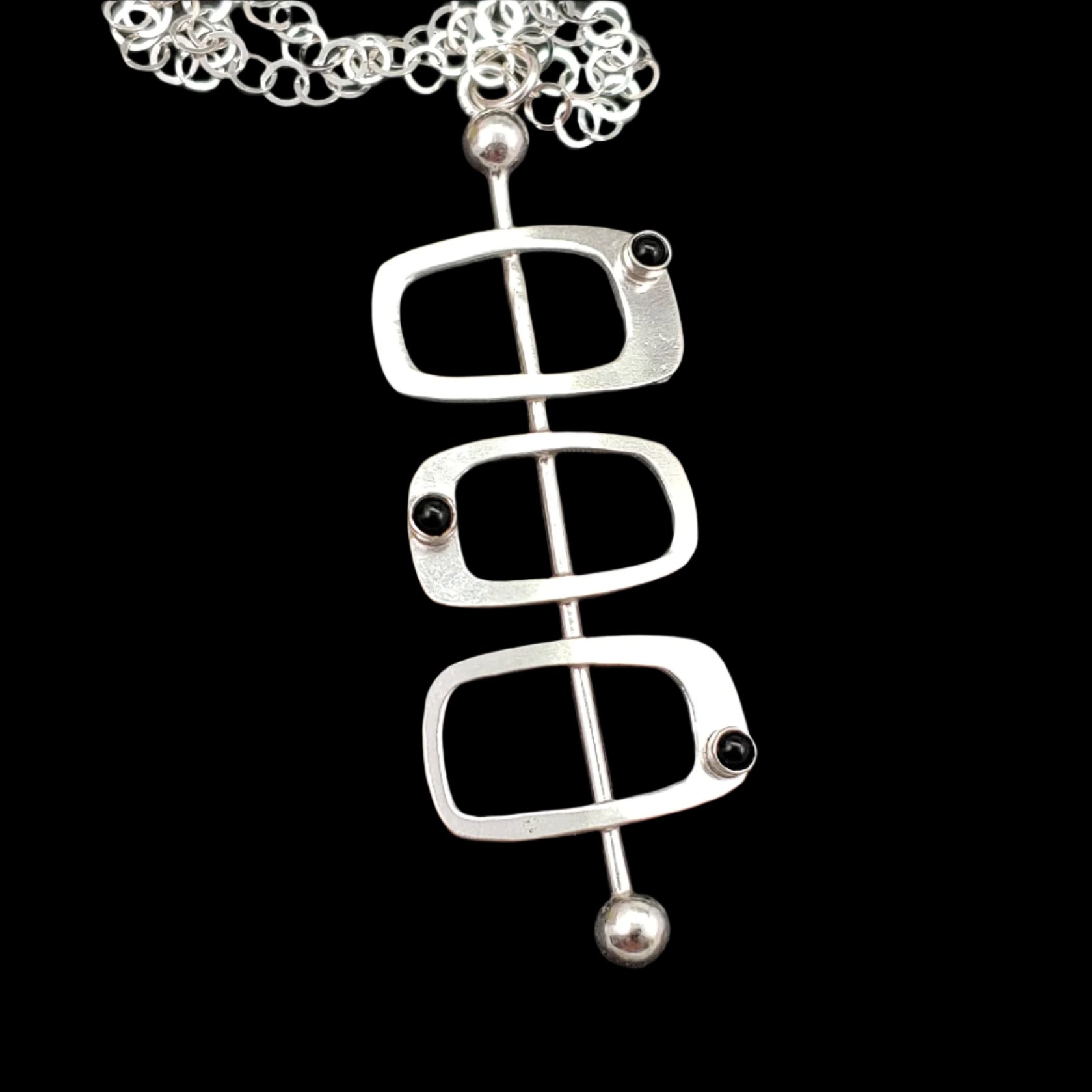 Handmade mid century modern style necklace in the Googie fashion with sterling silver rectangles and black onyx stone