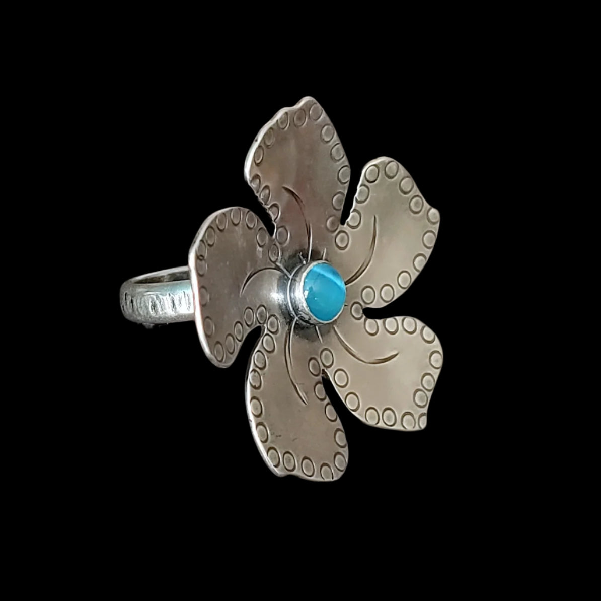 Sterling silver plumeria Tiki ring with light blue stone with fine detailing in an alternate view