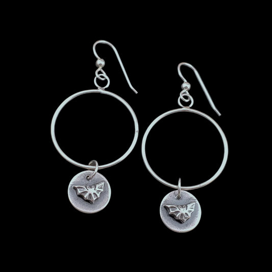 Photo of sterling silver hoops with small bat dangles.