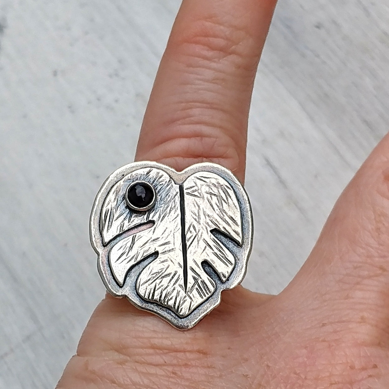 Monstera deliciosa ring on finger