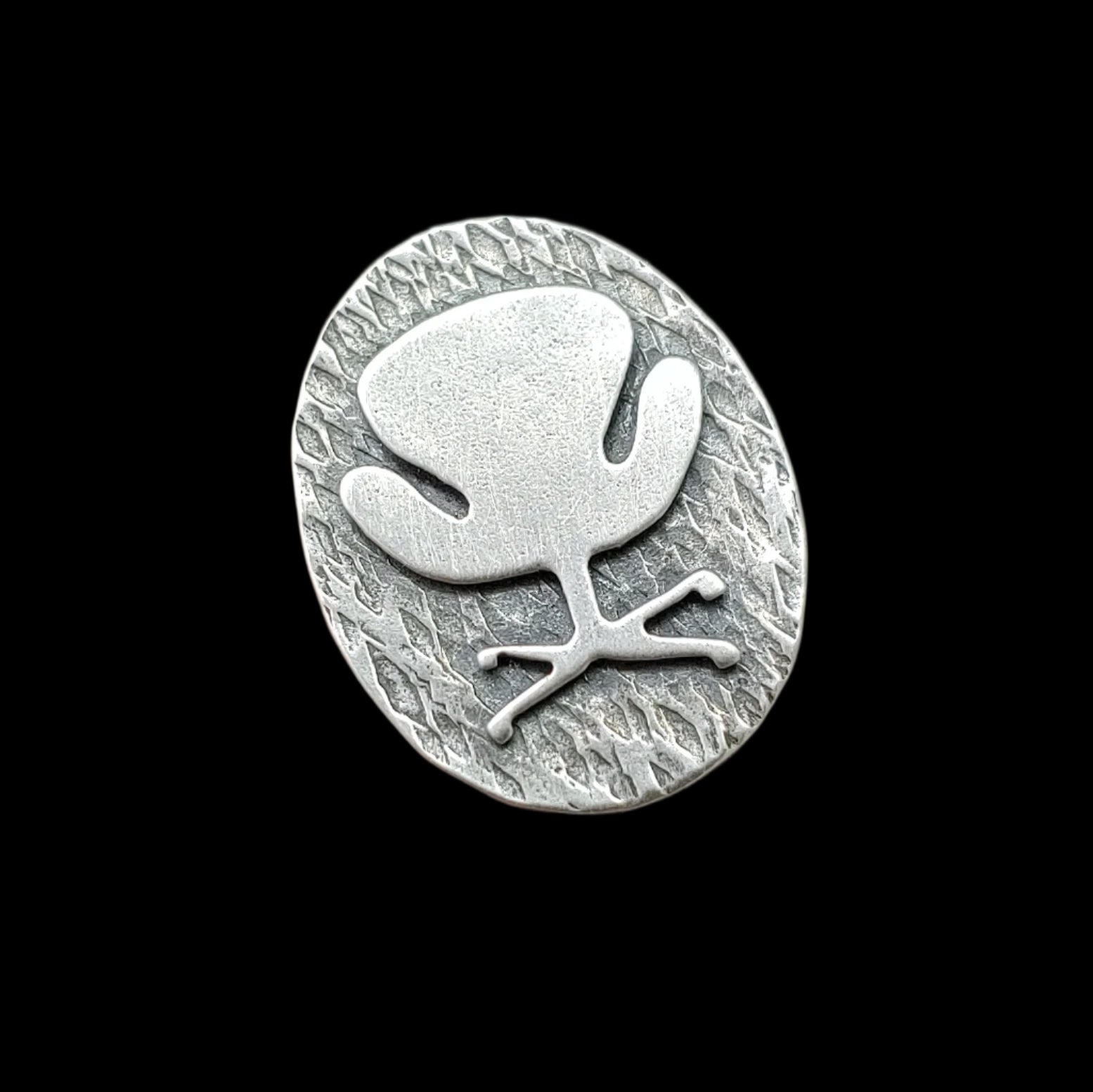 Front view of a Mid century modern Swan Chair ring handmade in sterling silver which is perfect as a 17th wedding anniversary gift of furniture as shown on a black background