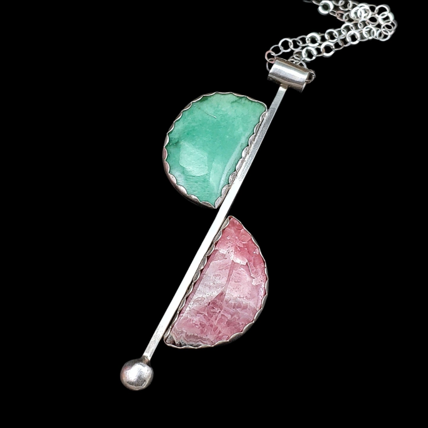 Mid century modern style in a sterling silver handmade necklace featuring rhodochrosite and variscite in a minimalistic half moon way