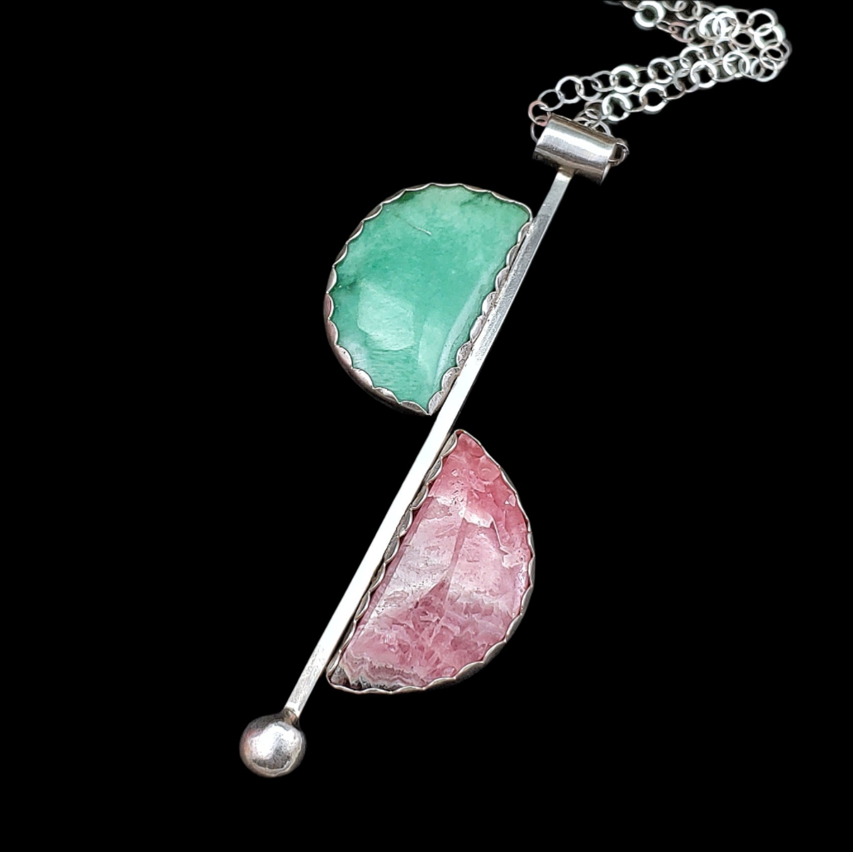 Mid century modern style in a sterling silver handmade necklace featuring rhodochrosite and variscite in a minimalistic half moon way