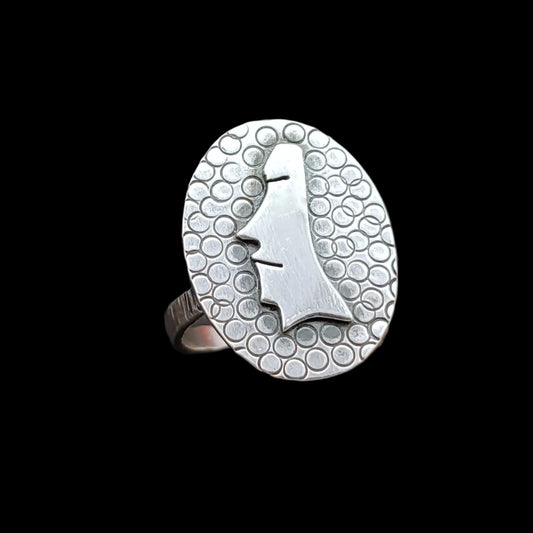Sterling silver moai head on a textured background ring
