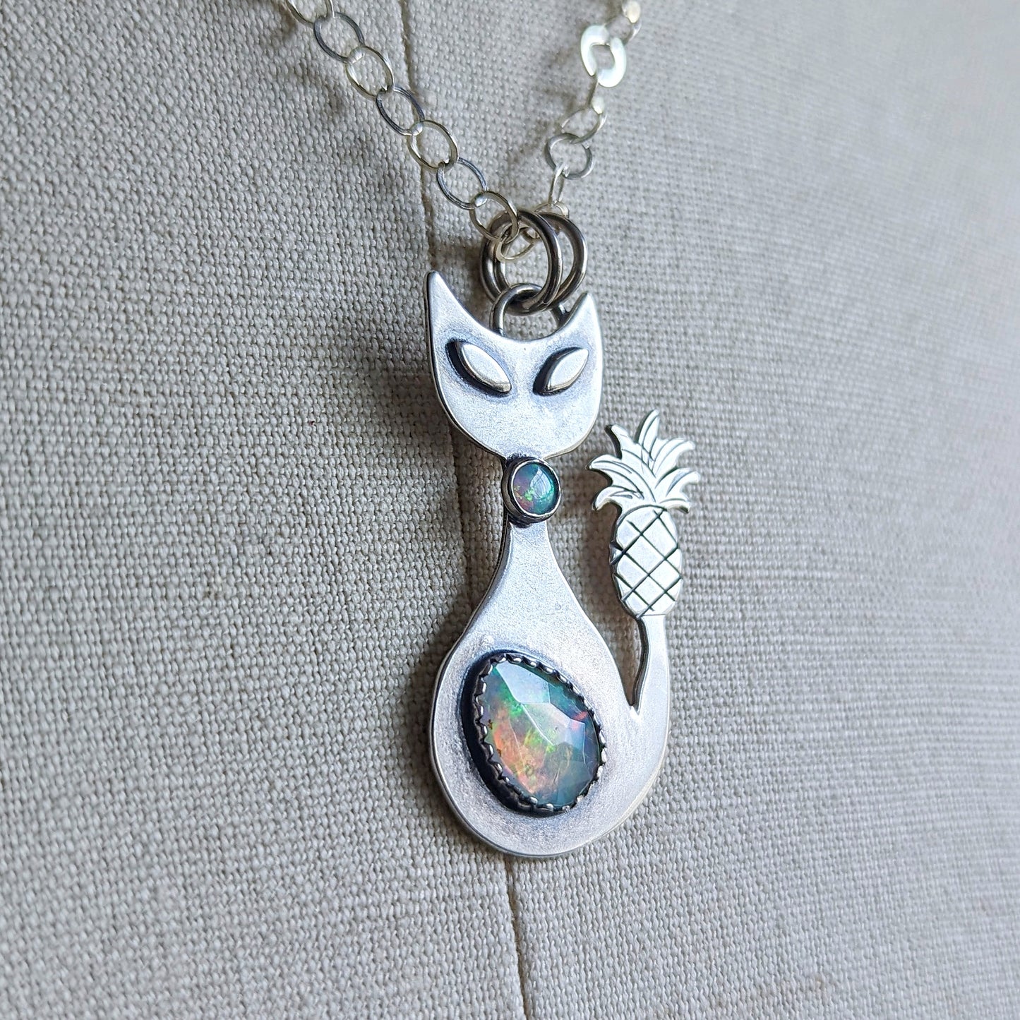 Sterling silver handmade cat with pineapple tail and Ethiopian opal close up