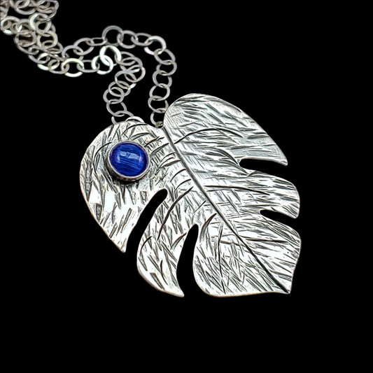 Sterling silver monstera leaf Tiki necklace featuring various gemstones